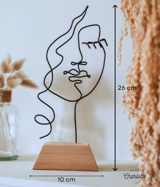 Visage de femme en fil de fer sur socle en bois