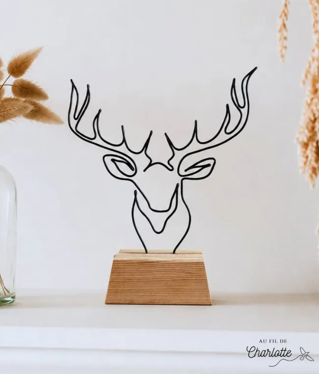 Tête de cerf en fil de fer sur socle en bois